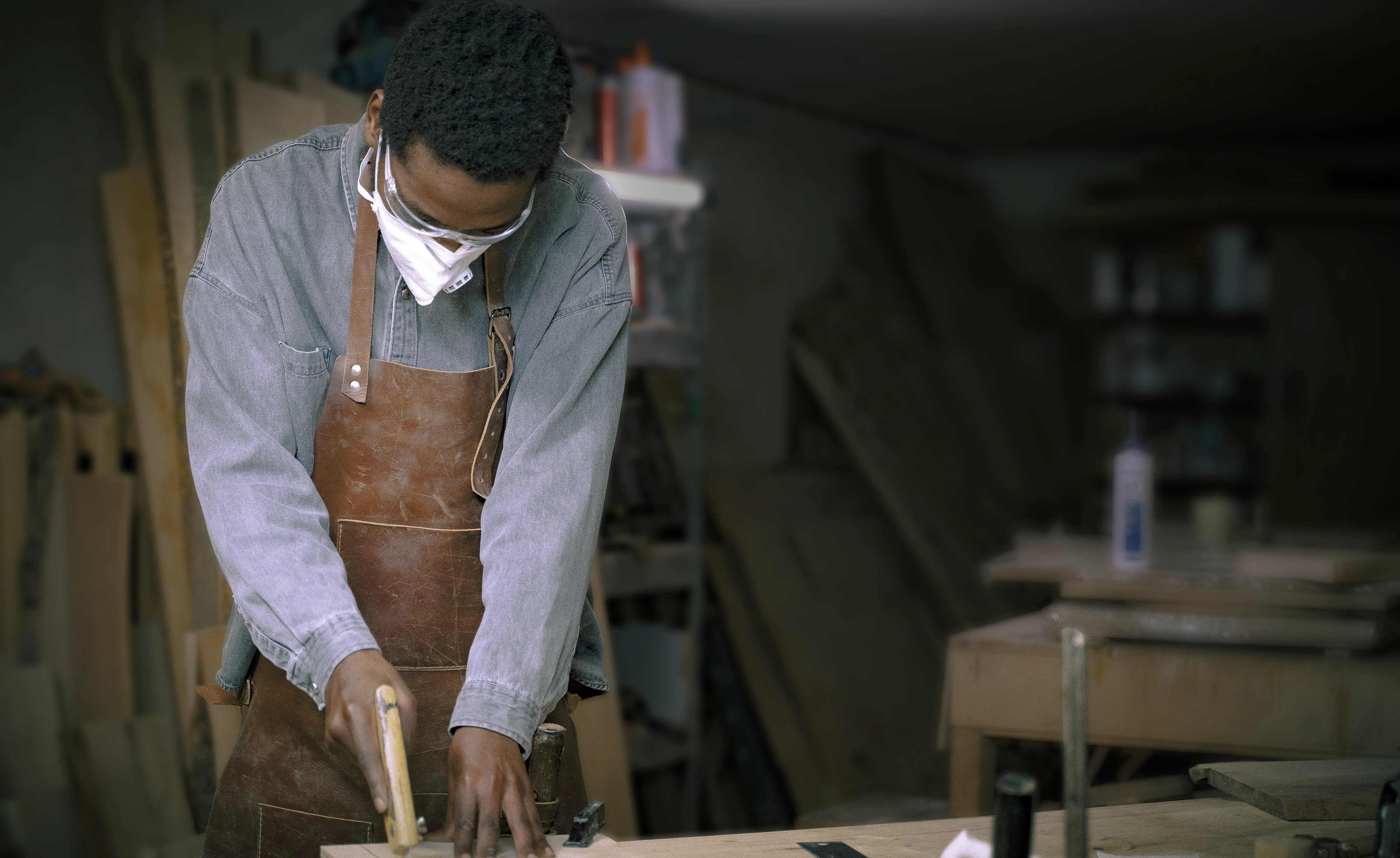 Bochi Tribe craftsman working with wood in the workshop